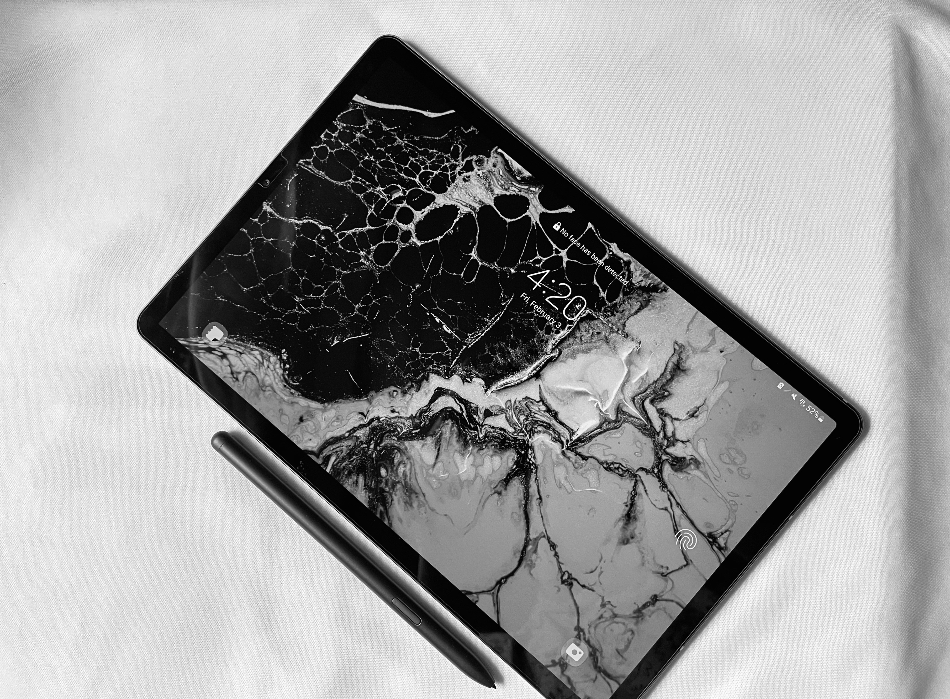 a tablet with a pen on top of it