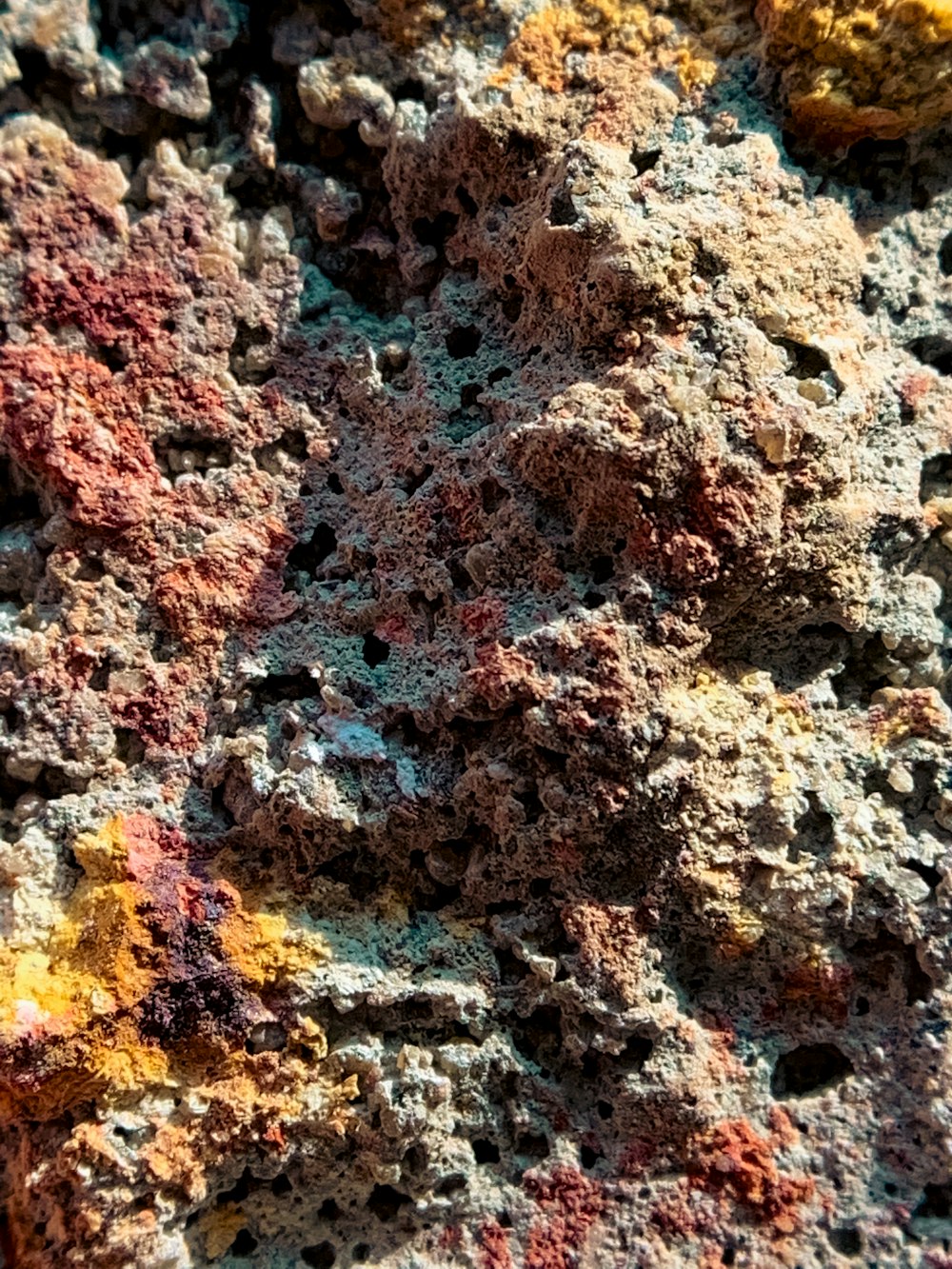 a close up of a rock with many different colored rocks