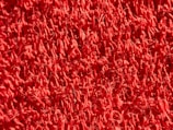 Close-up of the texture on a vibrant red carpet.