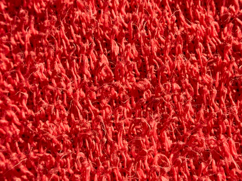 Detailed shot of a durable PVC swirl mat with vibrant colors in a retail store setting.