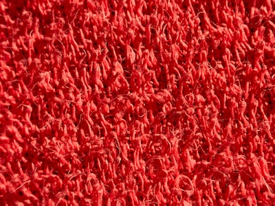 Close-up of the texture on a vibrant red carpet.