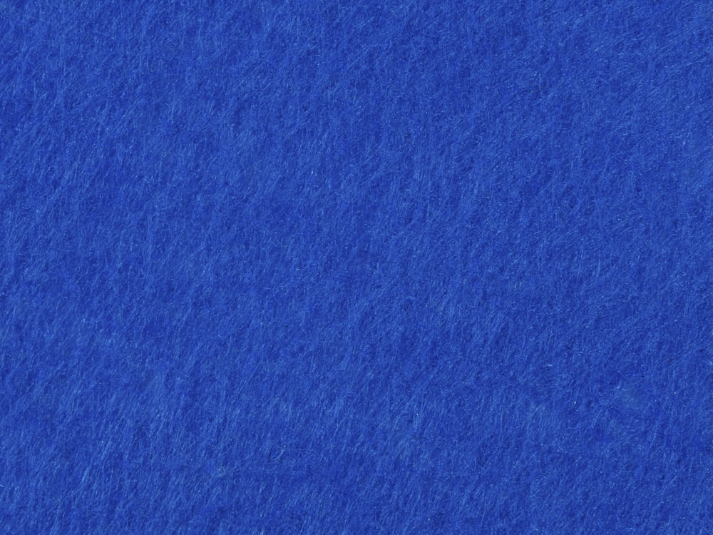 a blue background with a small plane flying in the sky