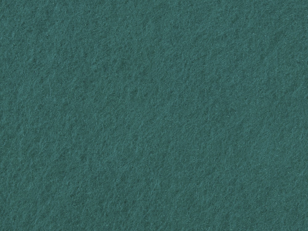 a close up of a green felt background