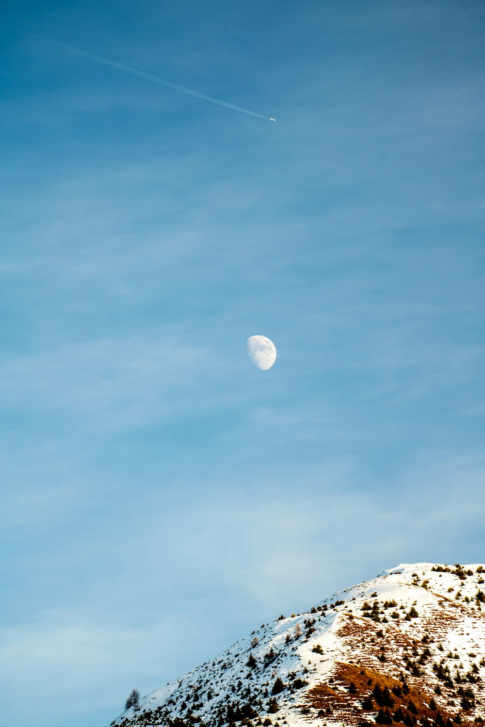 a view of the moon from the top of a mountain