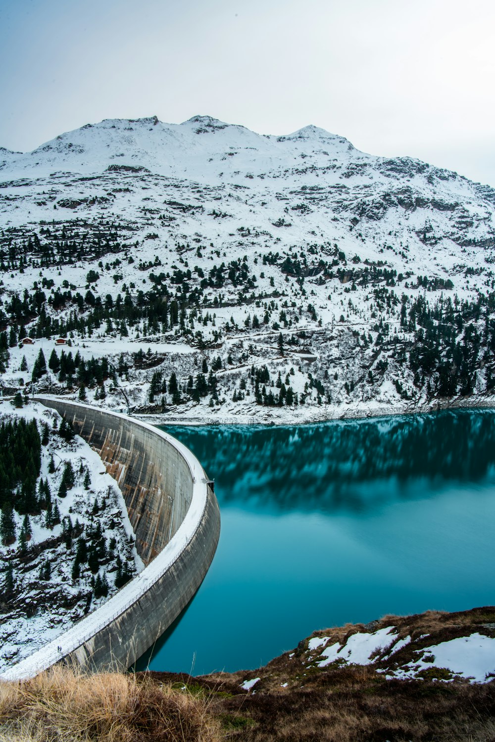 a large body of water surrounded by snow covered mountains