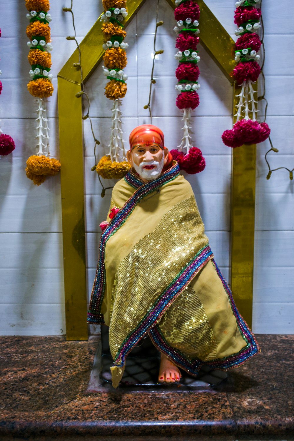 a statue of a man sitting on top of a counter