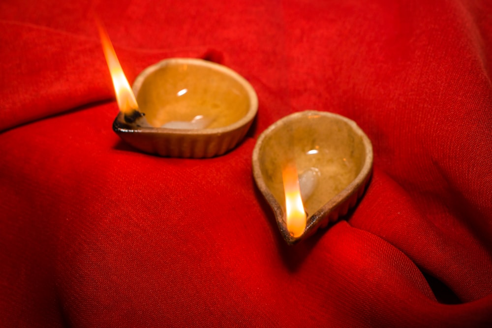 a couple of small bowls sitting on top of a red cloth