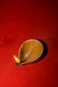 Elegant temple lamp burning steadily with golden Shree Aradhana pooja oil inside.