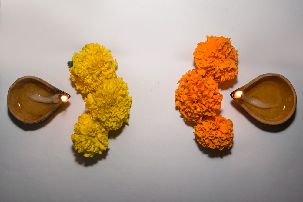 a couple of spoons filled with flowers on top of a table