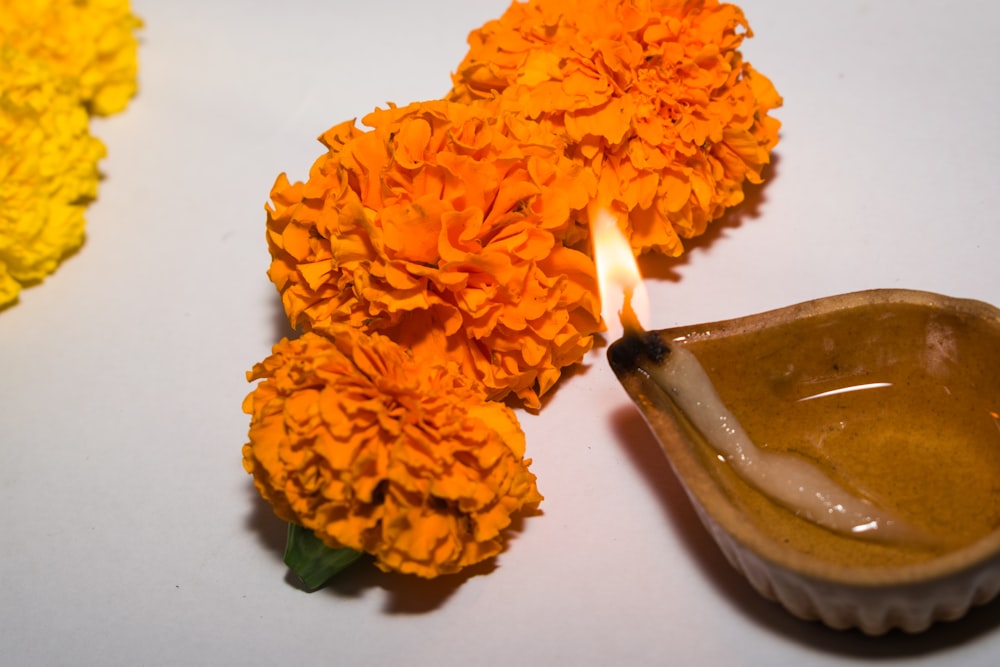 a candle is lit next to flowers on a table