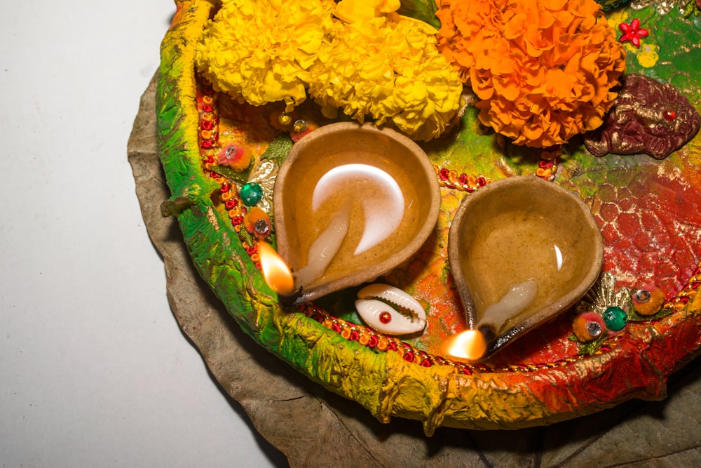 a decorative plate with shells and flowers on it