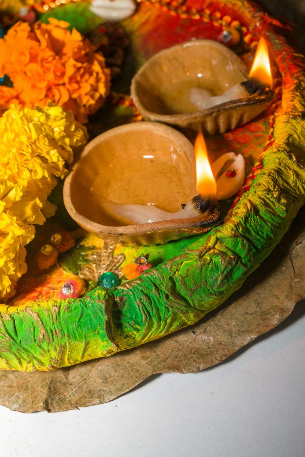 a decorative plate with candles and flowers on it