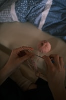 Hands of a person crocheting a simple pattern with pastel blue yarn