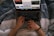 A happy shopper browsing products on a laptop with a cozy home setting.
