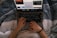 A happy customer browsing products on a laptop in a cozy home setting.