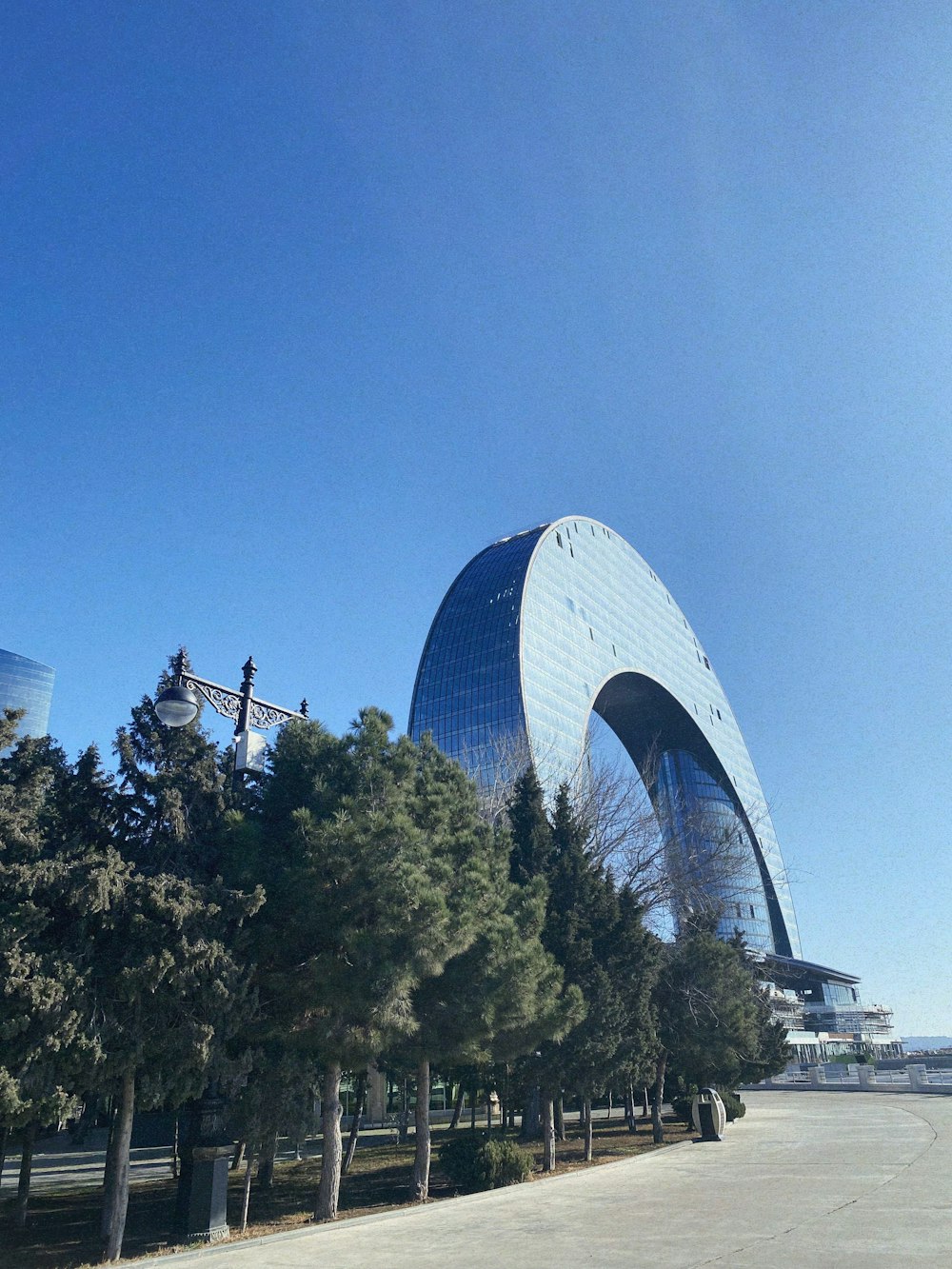 a very tall building sitting next to a bunch of trees