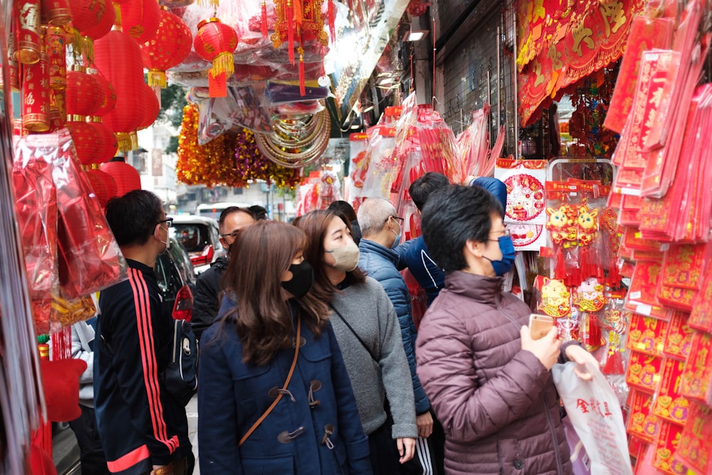 a group of people standing in front of a store