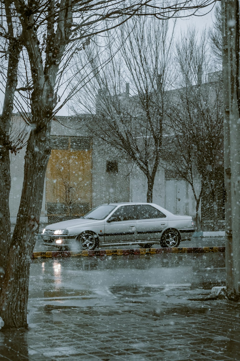 a car parked on the side of the road in the snow