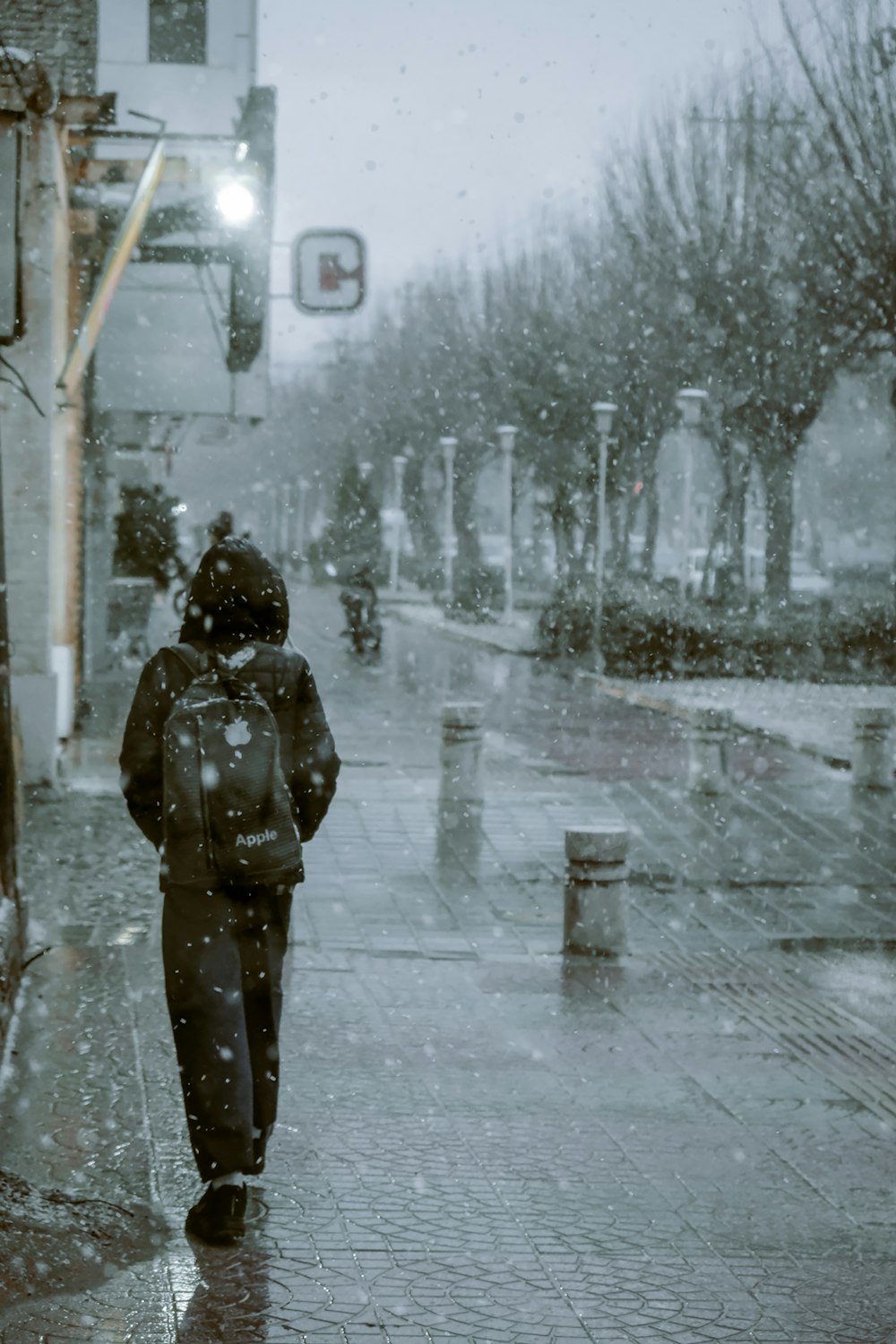 a person walking down a street in the rain