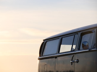 A sleek VIP van parked near Istanbul's iconic landmarks during sunset.