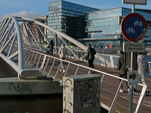 a group of people walking across a bridge