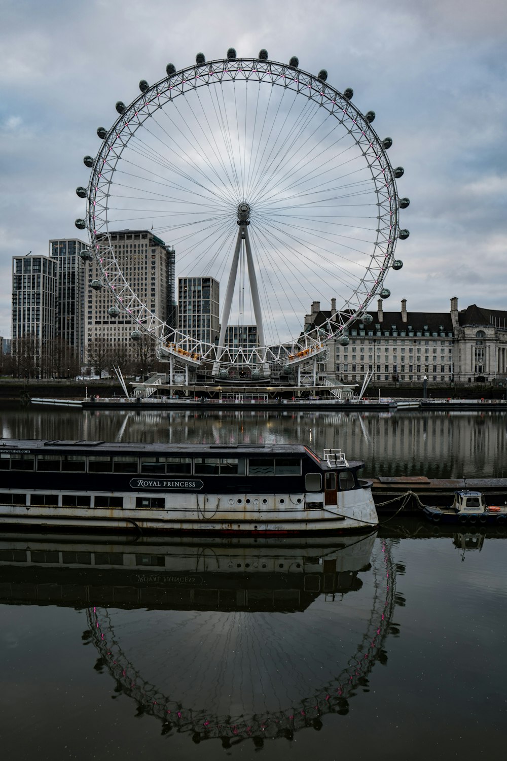 a large ferris wheel sitting next to a body of water