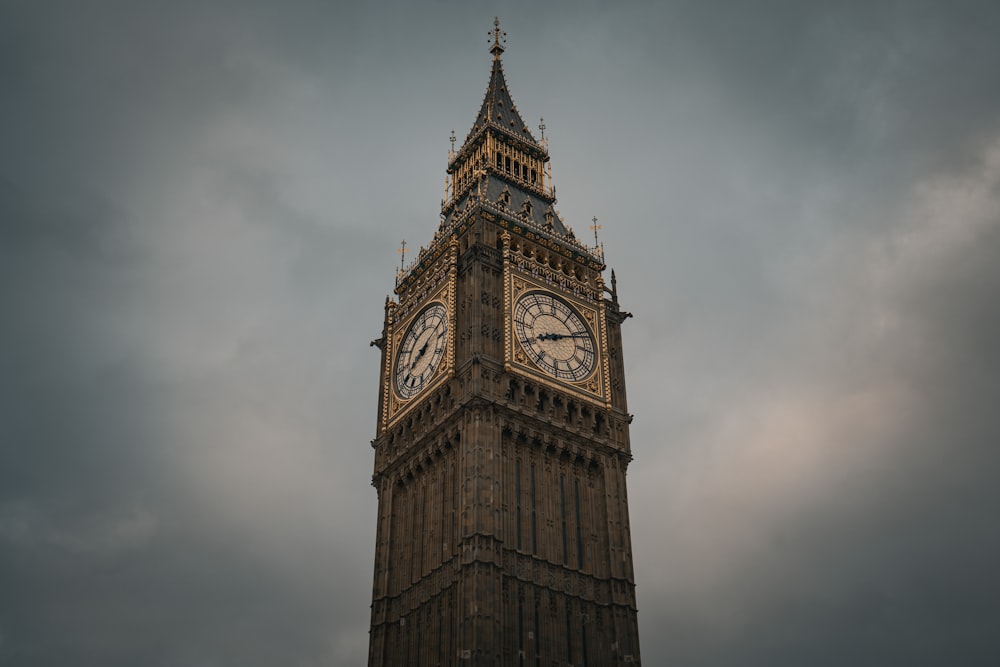 a tall clock tower with a cloudy sky in the background