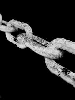 A close-up of a broken chain symbolizing a data breach and vulnerability.