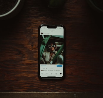 a cell phone sitting on top of a wooden table