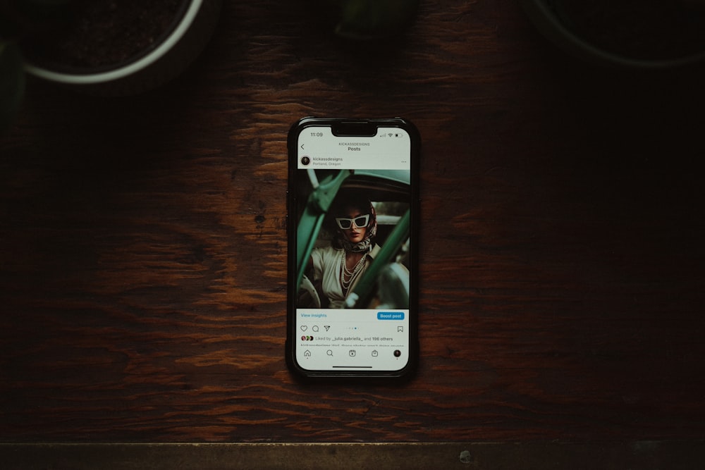 a cell phone sitting on top of a wooden table