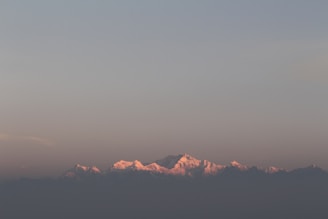 An inspiring image of a sunrise over mountains.