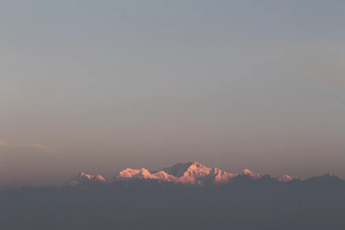 Album cover art featuring a sunrise over mountains with warm tones