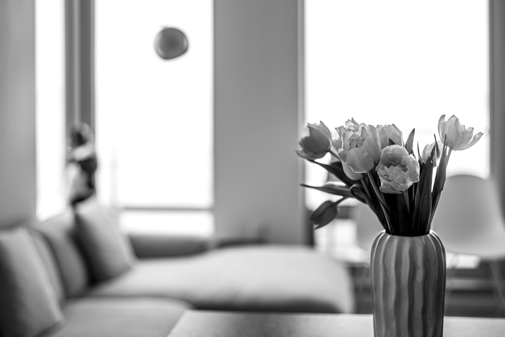 a vase filled with flowers sitting on top of a table