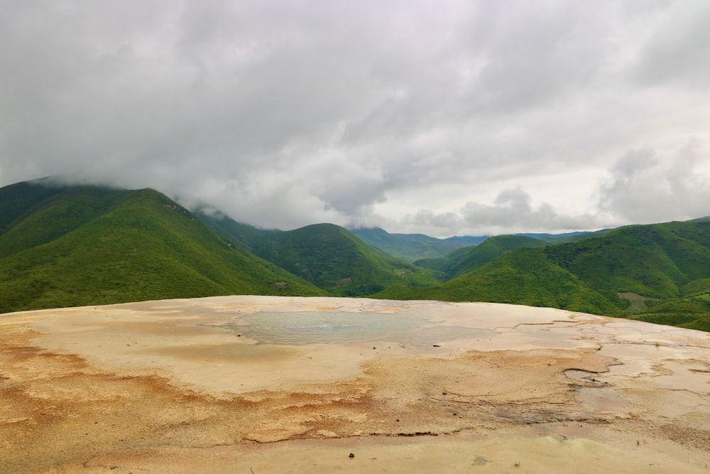 a view of a mountain range from a hot spring