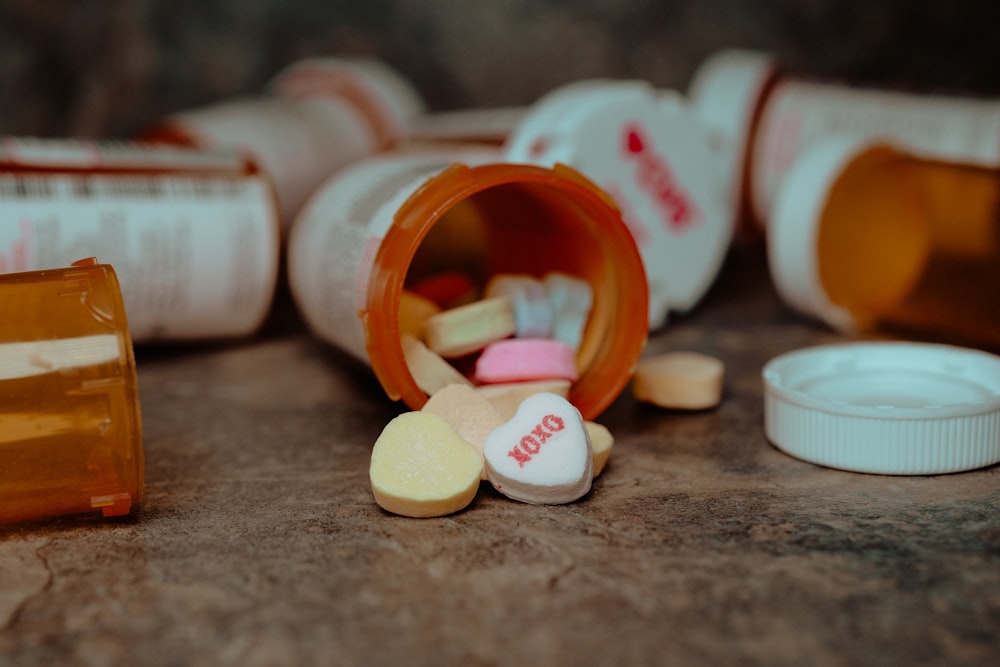 a close up of a pill bottle with pills spilling out of it