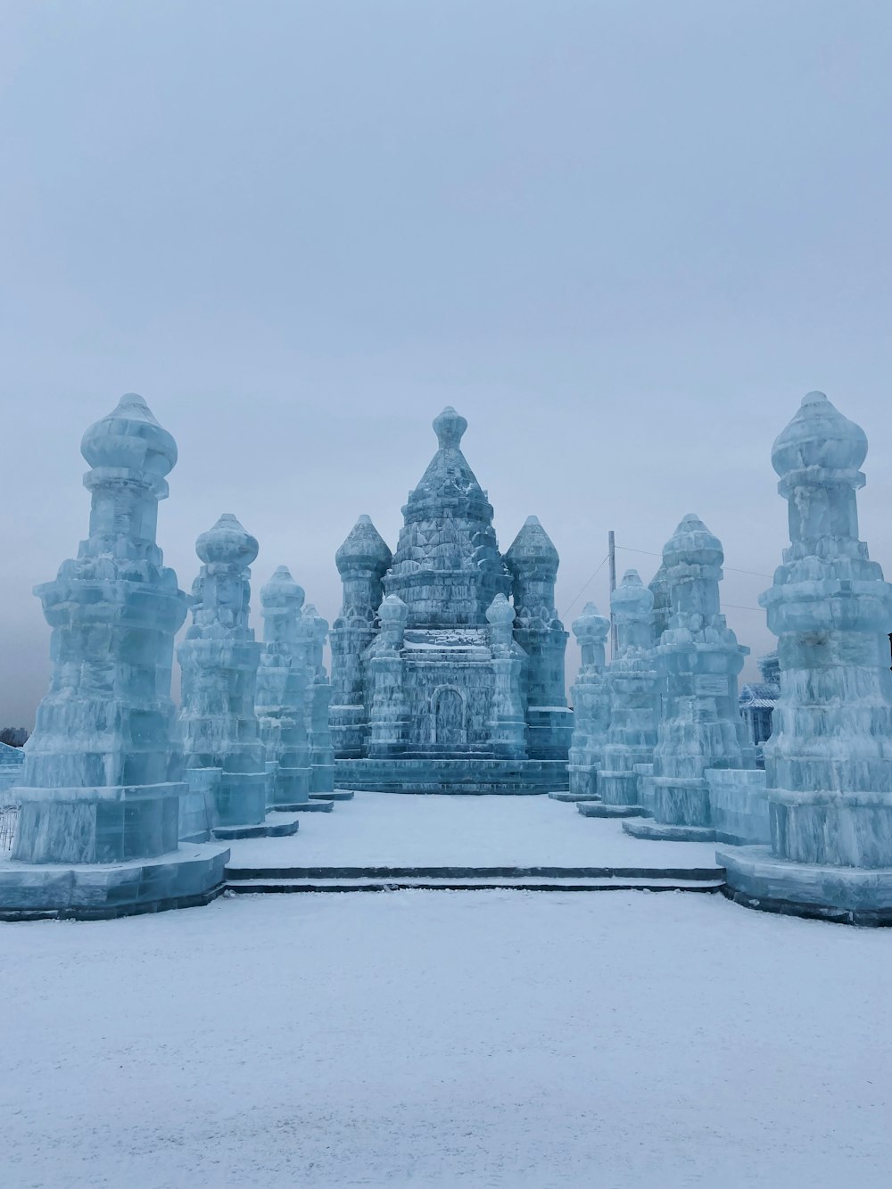 a group of ice sculptures sitting on top of a snow covered ground