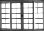 An array of custom sliding windows displayed in a bright showroom.