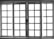 A set of white-framed sliding glass doors with multiple square panes, allowing bright light to pass through, creating a high contrast between the dark frame and the bright background.