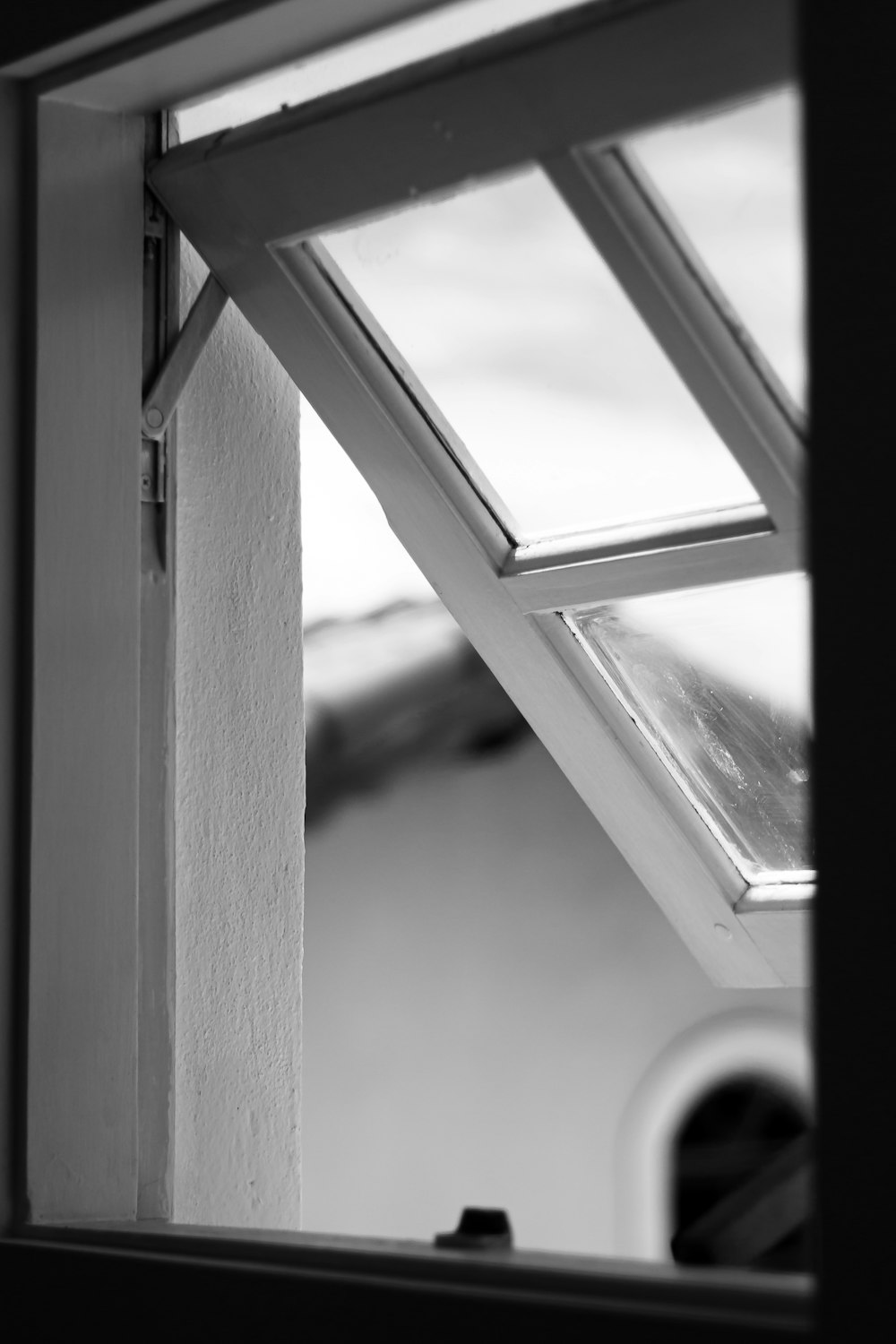a black and white photo of a window with a skylight