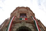 a building with a flag hanging from the top of it