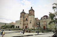 a group of people standing in front of a large building