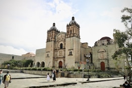 a group of people standing in front of a large building