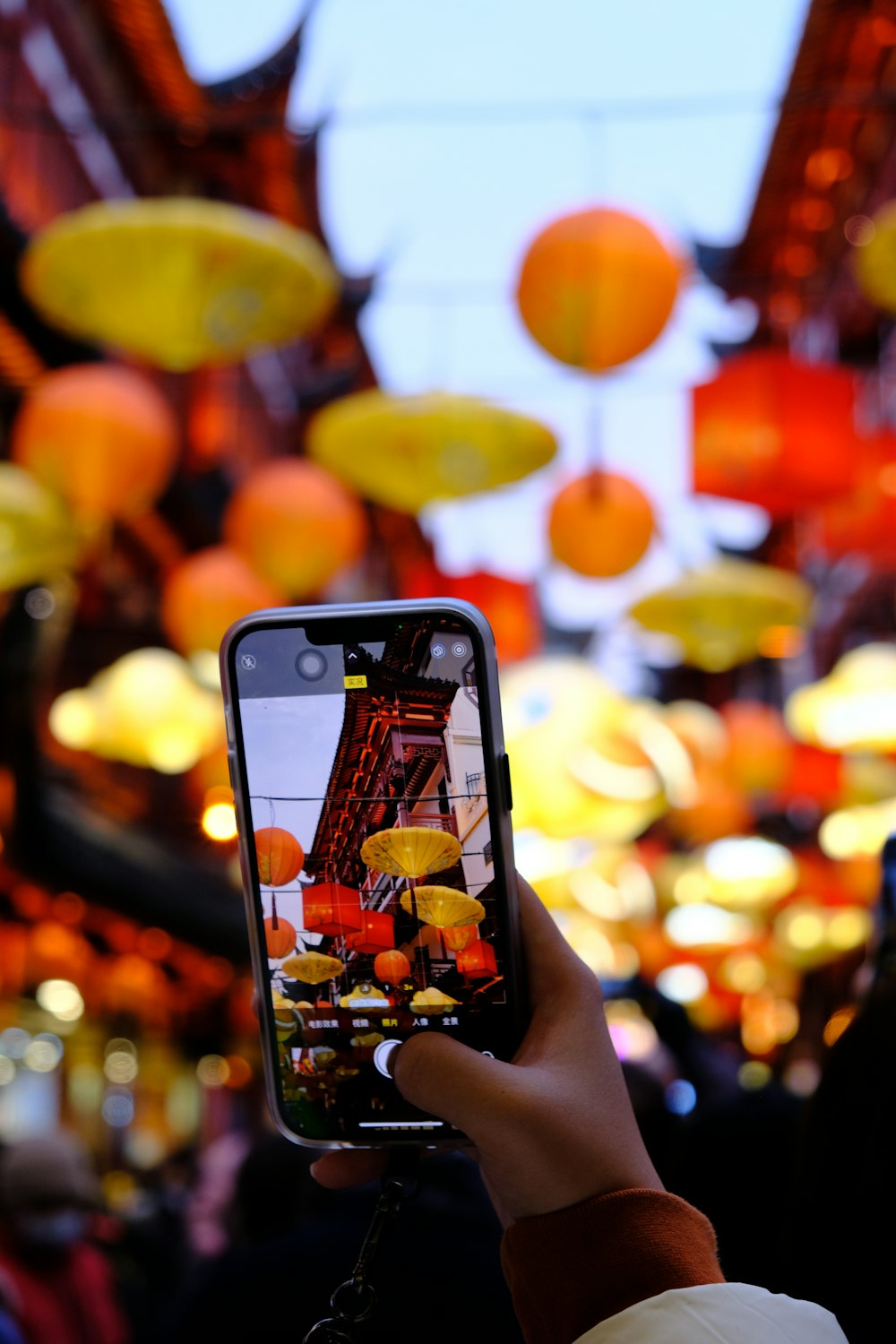 a person taking a picture of the eiffel tower