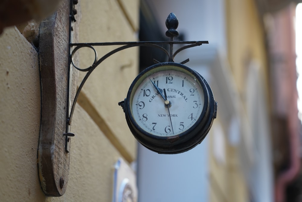 a clock hanging from the side of a building