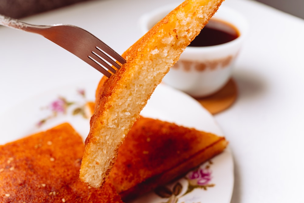 a fork sticking out of a piece of cake