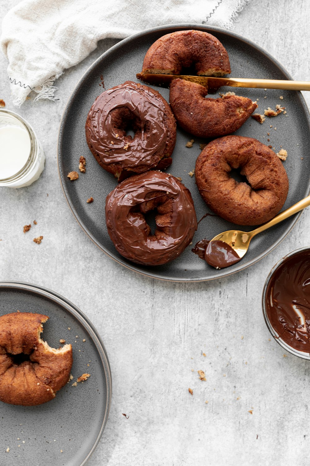 a plate of doughnuts with chocolate frosting