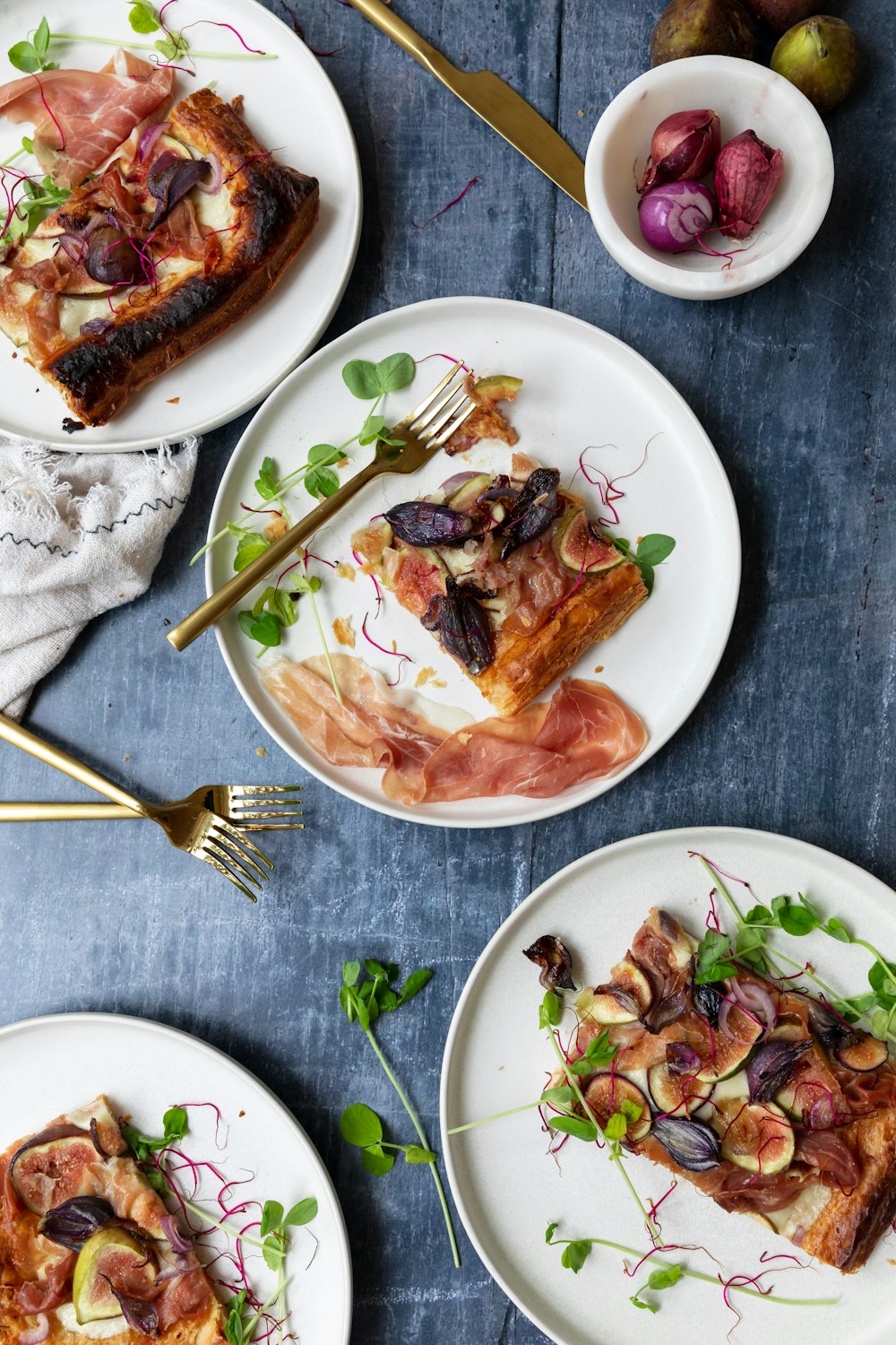 a table topped with three plates of food