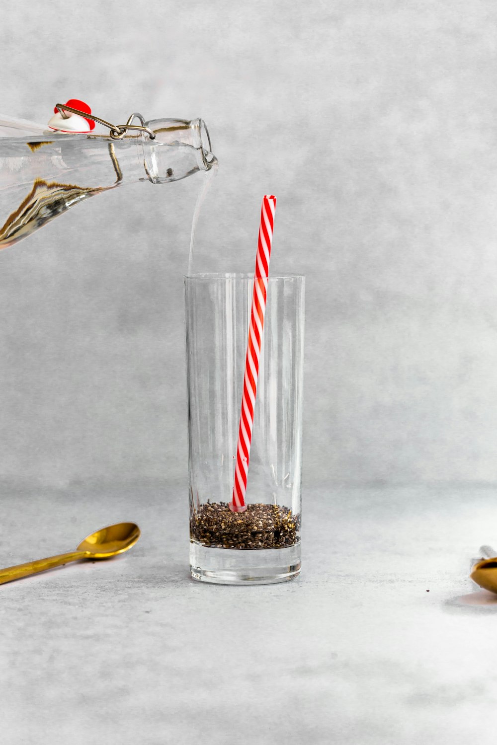 a red and white striped straw sticking out of a glass