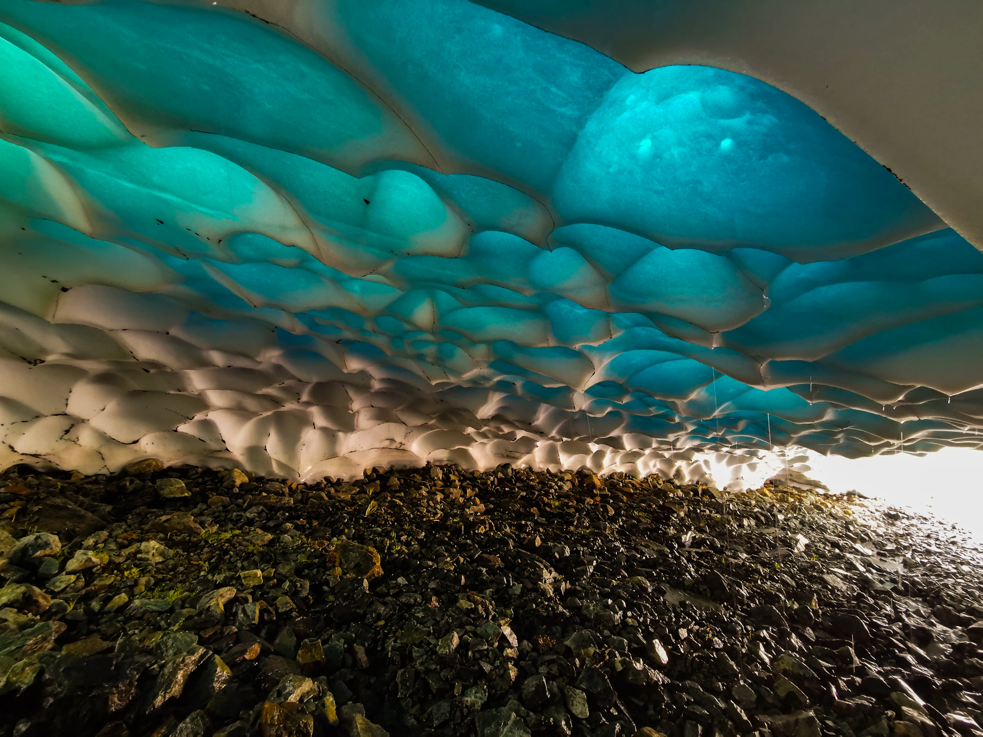 A mesmerizing video still of sunlight glinting off a glacier's textured ice surface, highlighting its intricate layers.
