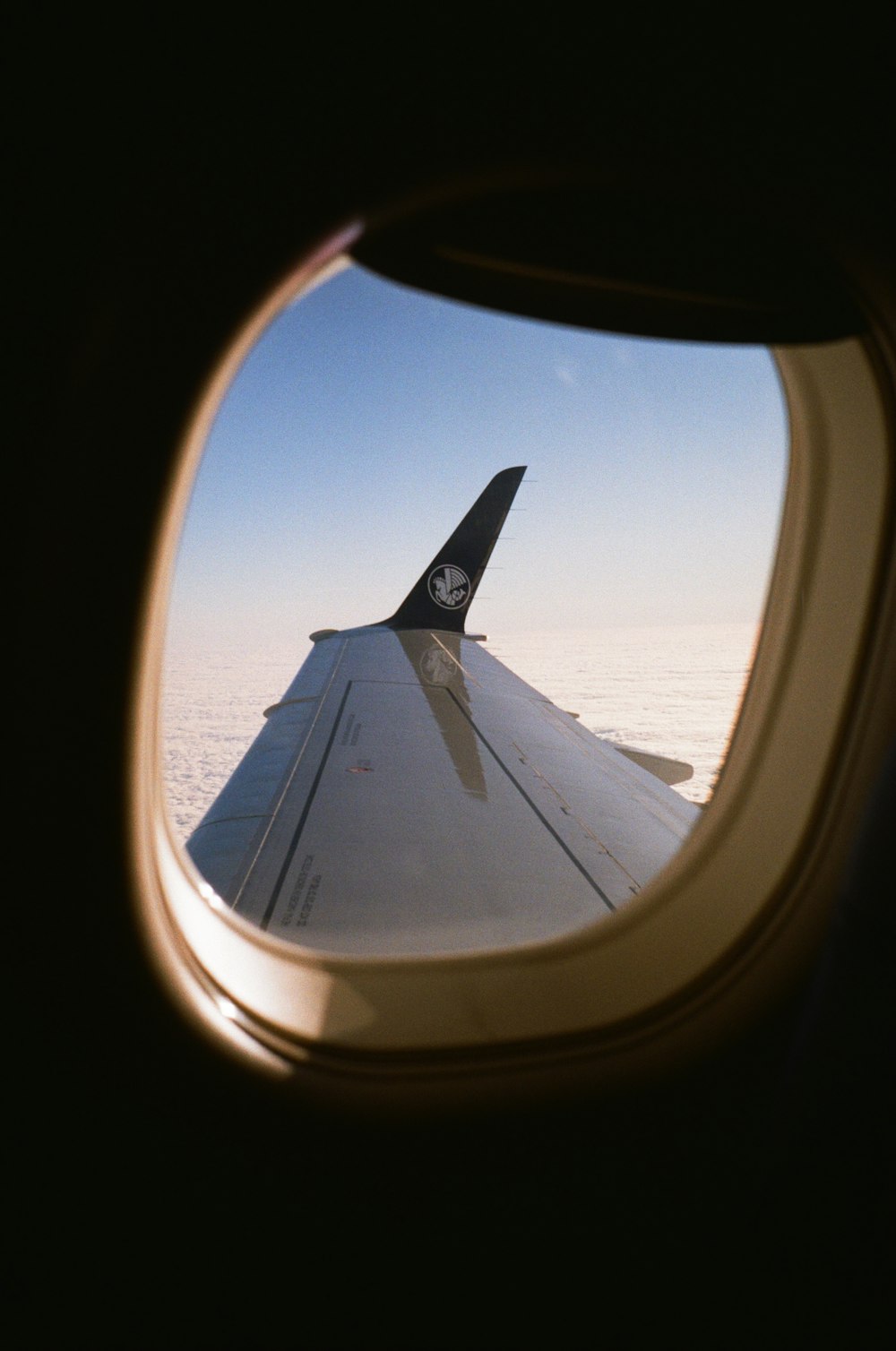 a view of the wing of an airplane through a window